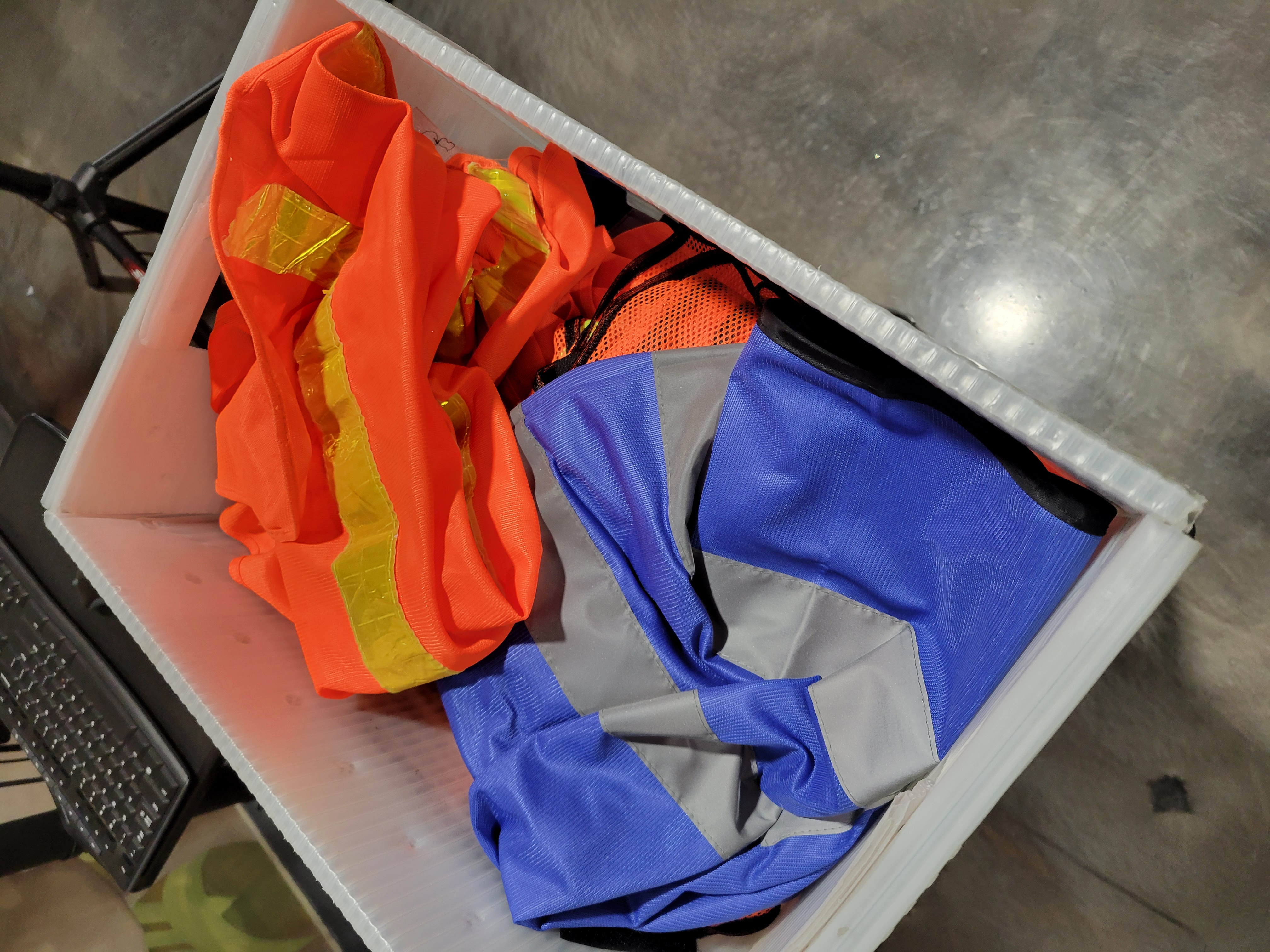 Orange and blue safety vest in a container.
